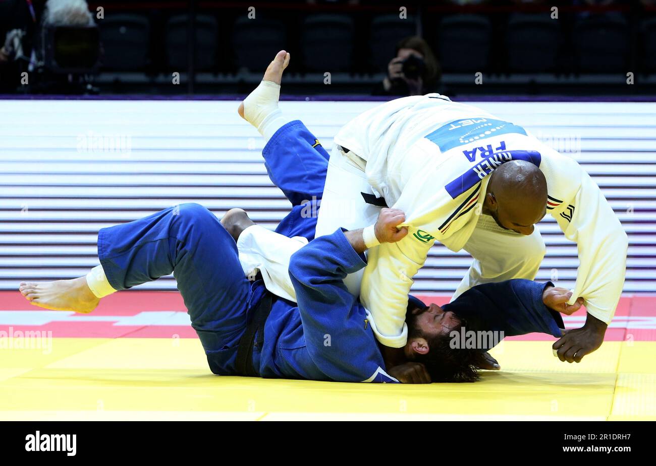 Teddy Riner of France, in white, and Inal Tasoev, INA, compete during ...