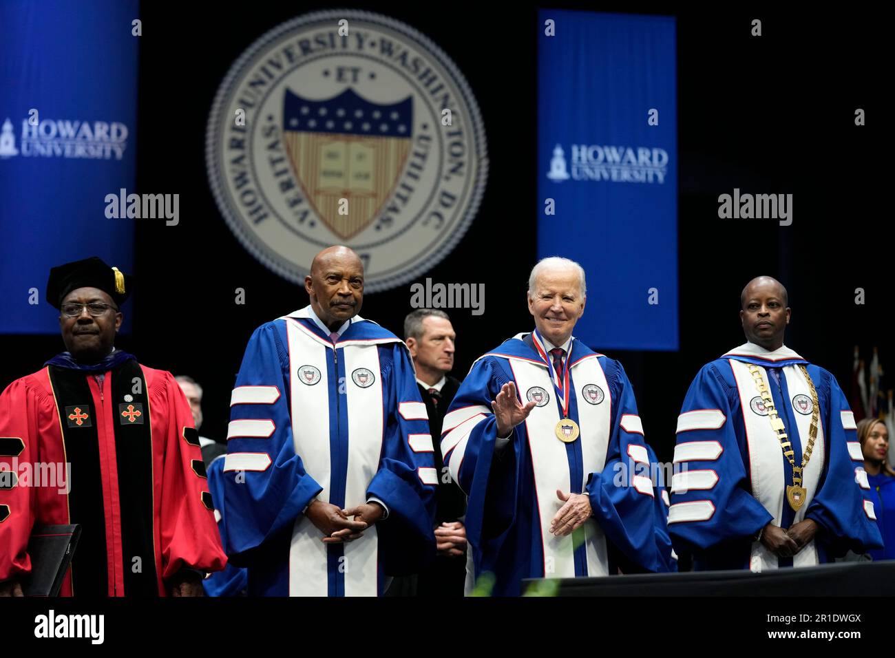 President Joe Biden waves as he stands with Howard University President ...