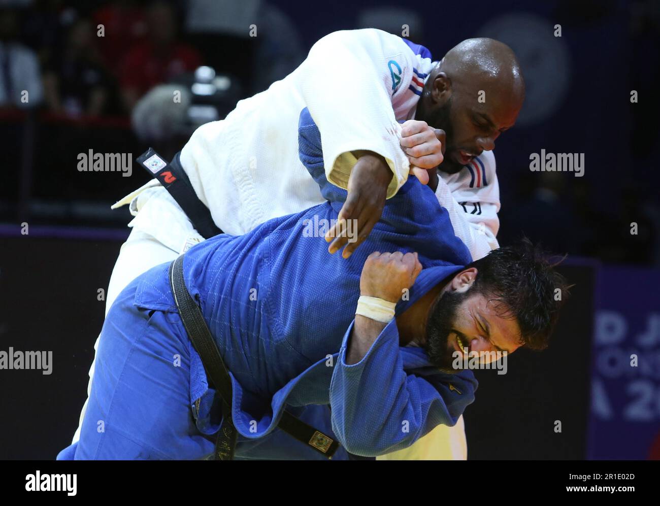 Teddy Riner of France, in white, and Inal Tasoev, INA, compete during ...