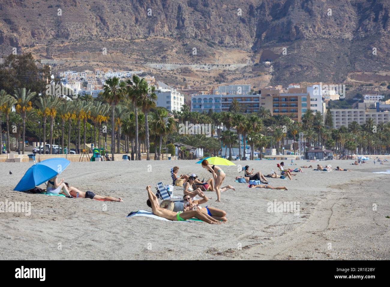 People sunbathing on the beach in aguadulce, almeria, spain Stock Photo