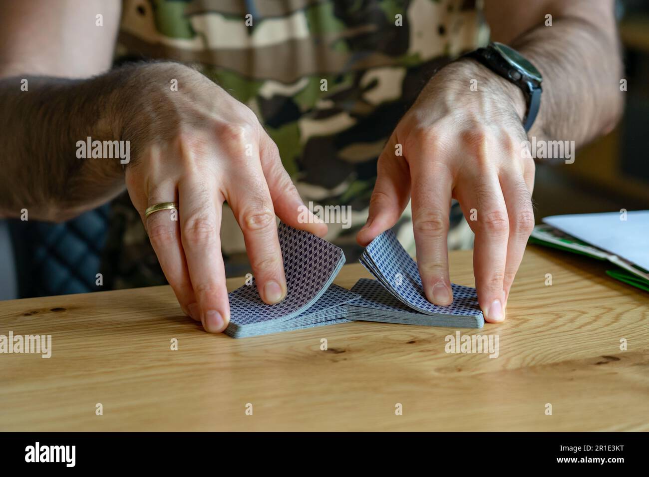 man shuffle cards while playing with friends . Stock Photo