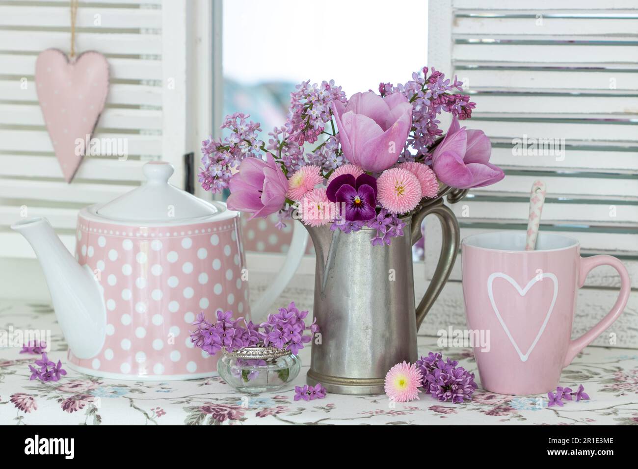 Violet cup of morning coffee or cappuccino and delicate purple, lilac  flowers. Mother's day concept. Cozy breakfast Stock Photo - Alamy