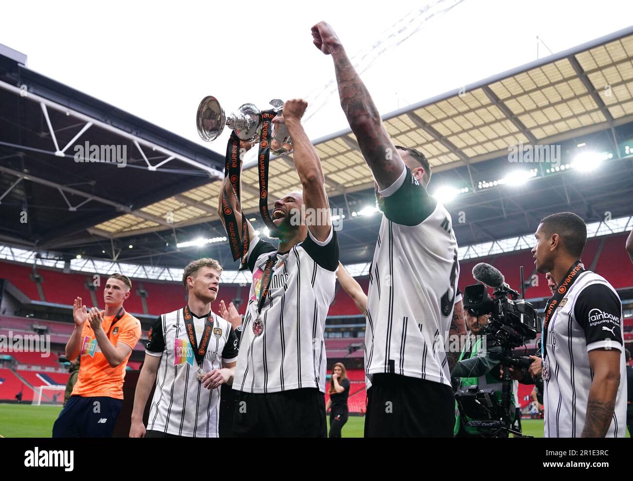 Notts County's John Bostock celebrates with the trophy after the
