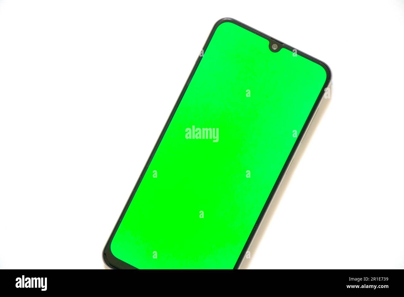 touchscreen phone with a green screen on a light background Stock Photo