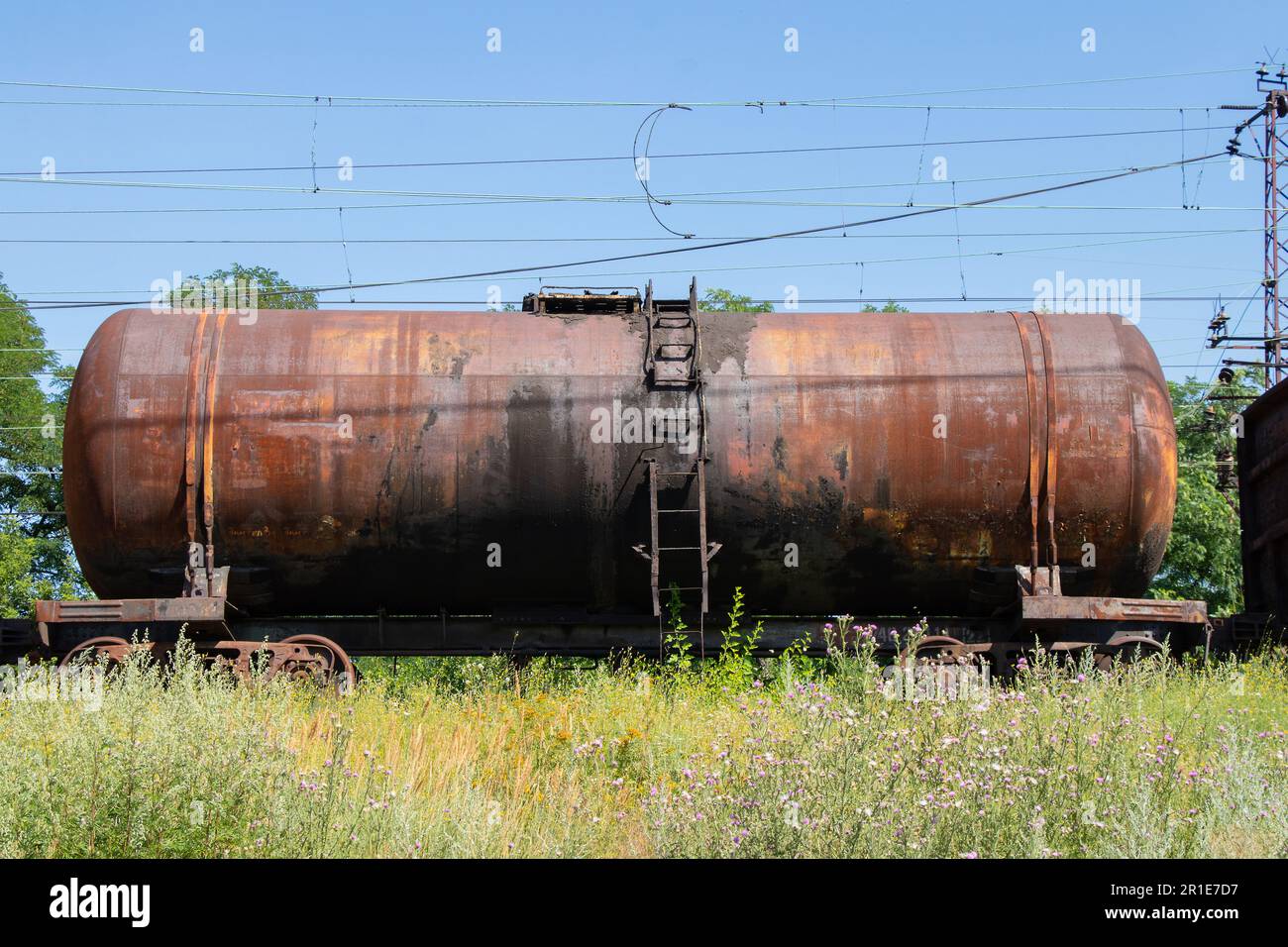 old decommissioned tank for oil transportation stands on the railway Stock Photo