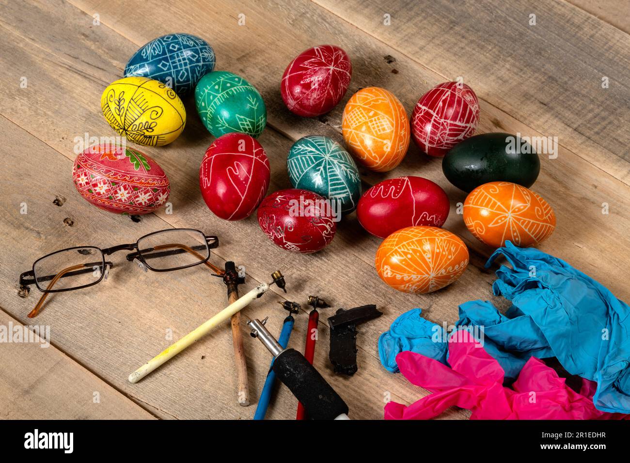 Hand painted painted Easter eggs and decorating materials for making Easter eggs. Painting Easter eggs with hot wax. Stock Photo