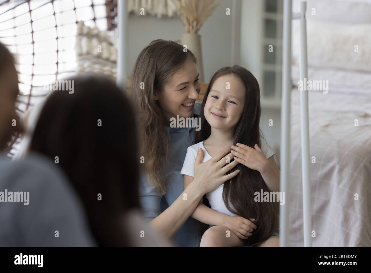 Happy young mom cuddling beautiful little girl kid Stock Photo - Alamy