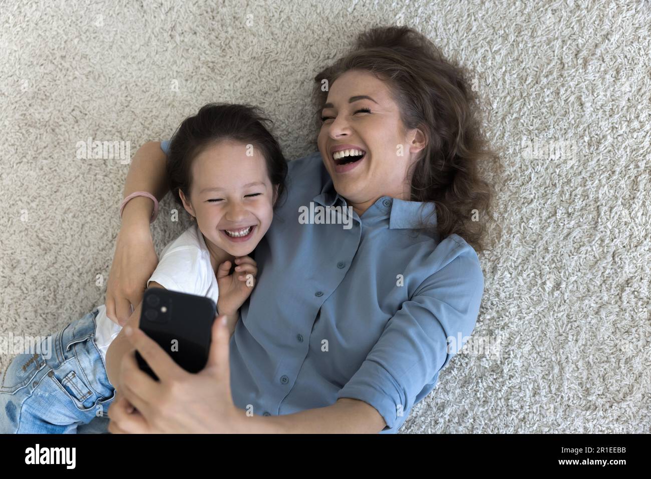 Cheerful young mom hugging happy sweet little kid girl Stock Photo - Alamy