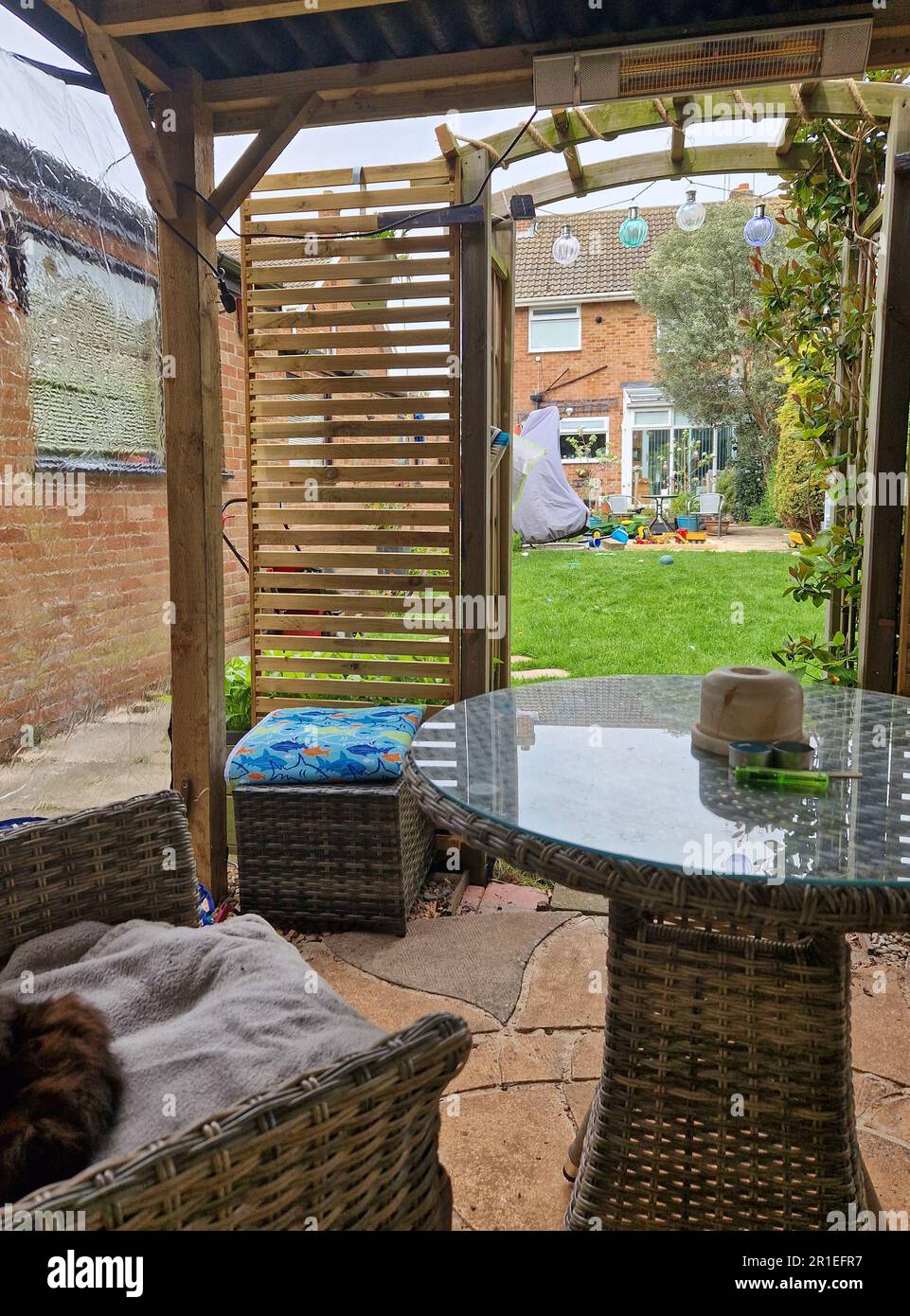 Patio furniture under a wooden gazebo Stock Photo Alamy
