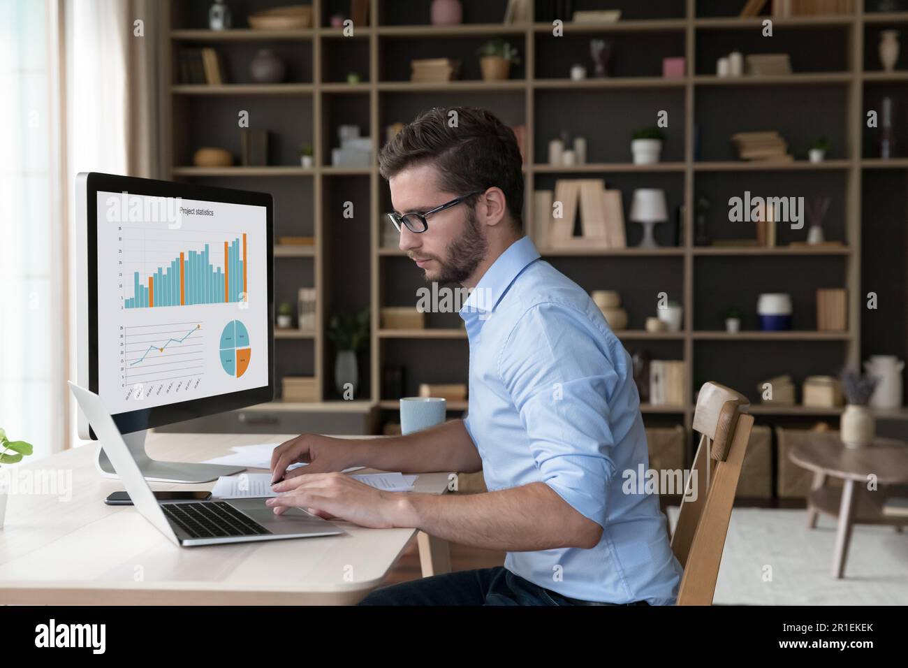 Focused young freelance business man analyzing financial data Stock Photo