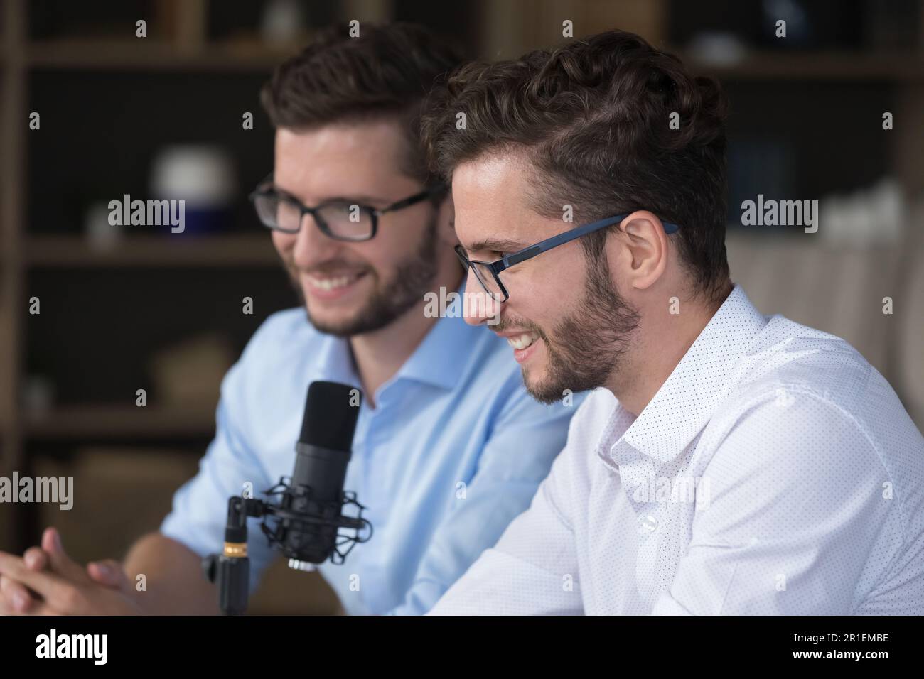 Happy positive young adult twin brothers broadcasting on air Stock