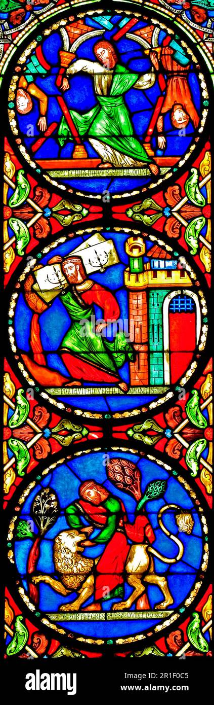 Stained Glass window, Story of Samson, killing a lion, striding away with gates of Gaza, pushing down the pillars to destroy the Philistines, by Alfre Stock Photo