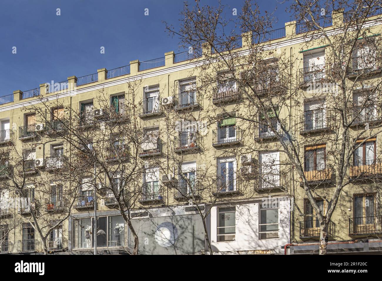 Facade of a four-story residential building with balconies with wrought ...