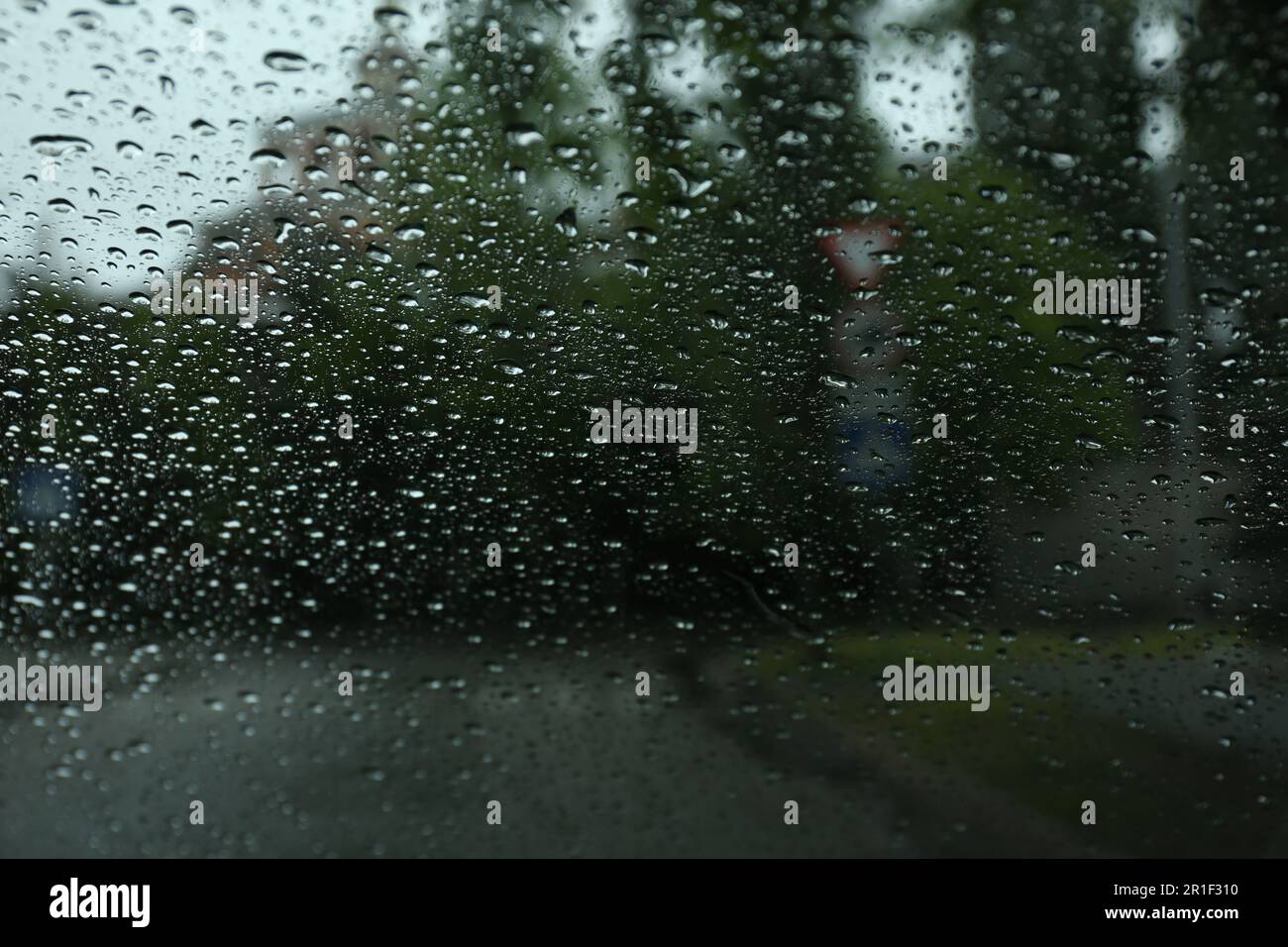 Blurred view of road through wet car window. Rainy weather Stock Photo ...