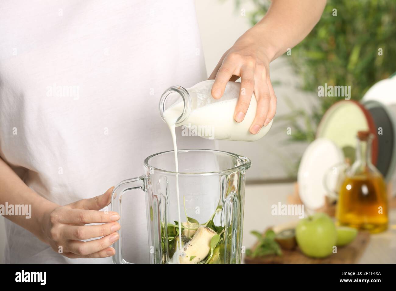 close up of woman hand pouring milk to blender Stock Photo - Alamy