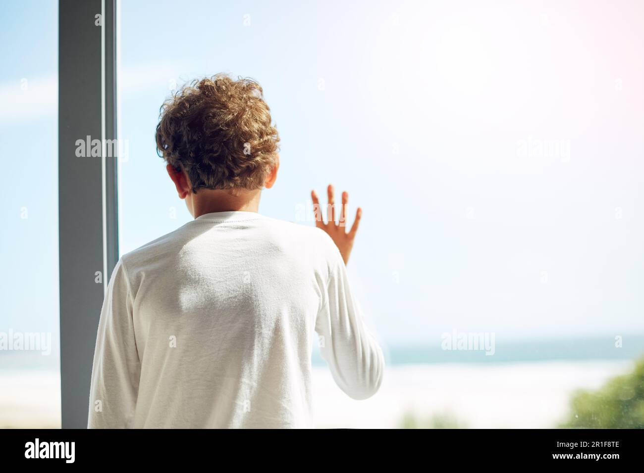 Sad, depression and hope of a child at window while bored lonely and ...