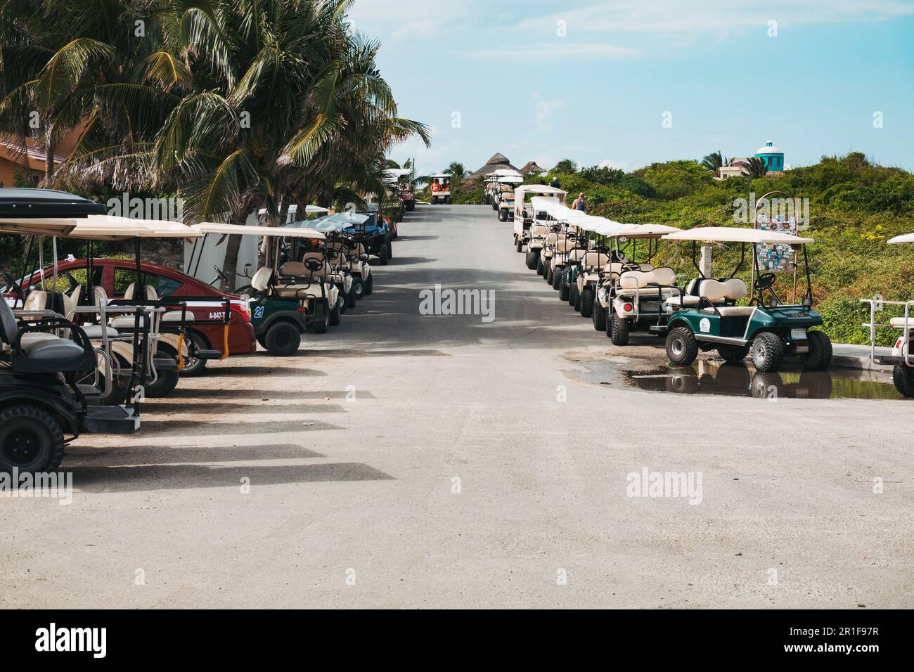 golf carts line the streets of Isla Mujeres, Yucatan, Mexico. The buggies are a popular way of getting around the island Stock Photo