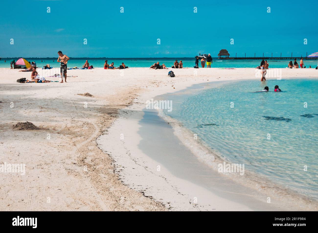 holidaymakers relax by a lagoon next to the MÍA Reef resort on the North Beach, Isla Mujeres, Yucatan, Mexico Stock Photo