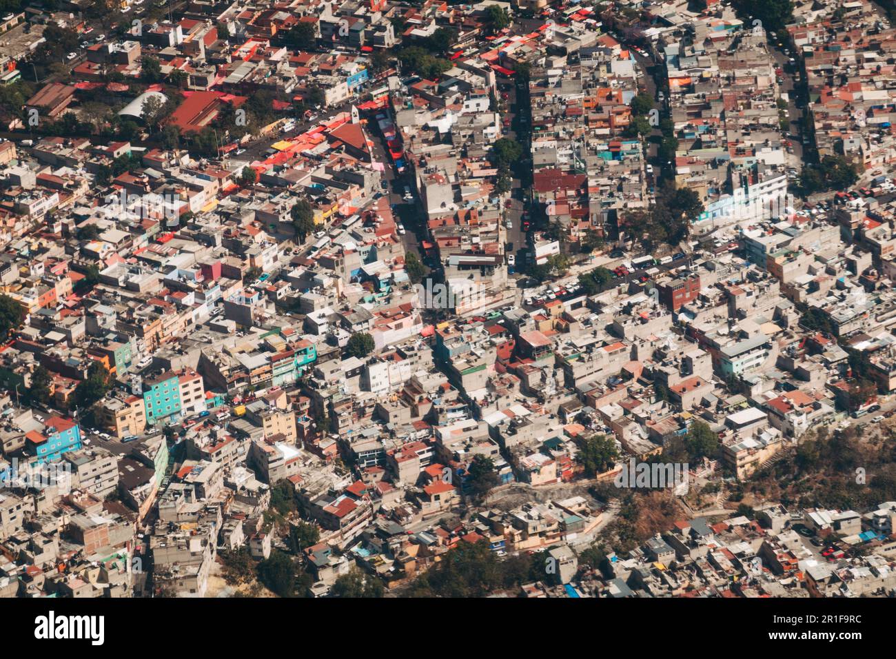 An aerial view of the colorful walls and roofs of houses in the outer suburbs of Mexico City Stock Photo