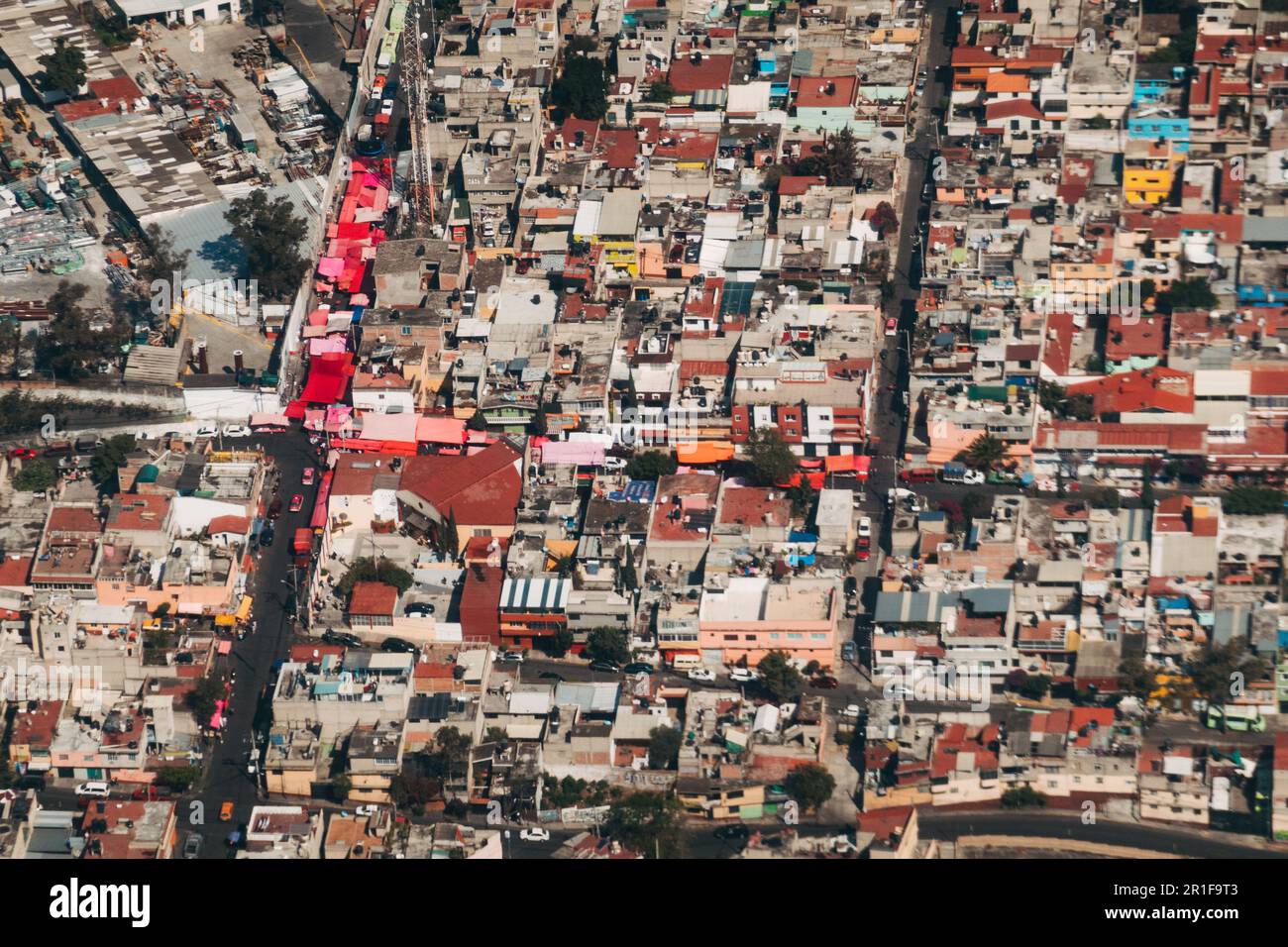 An aerial view of the colorful walls and roofs of houses in the outer suburbs of Mexico City Stock Photo