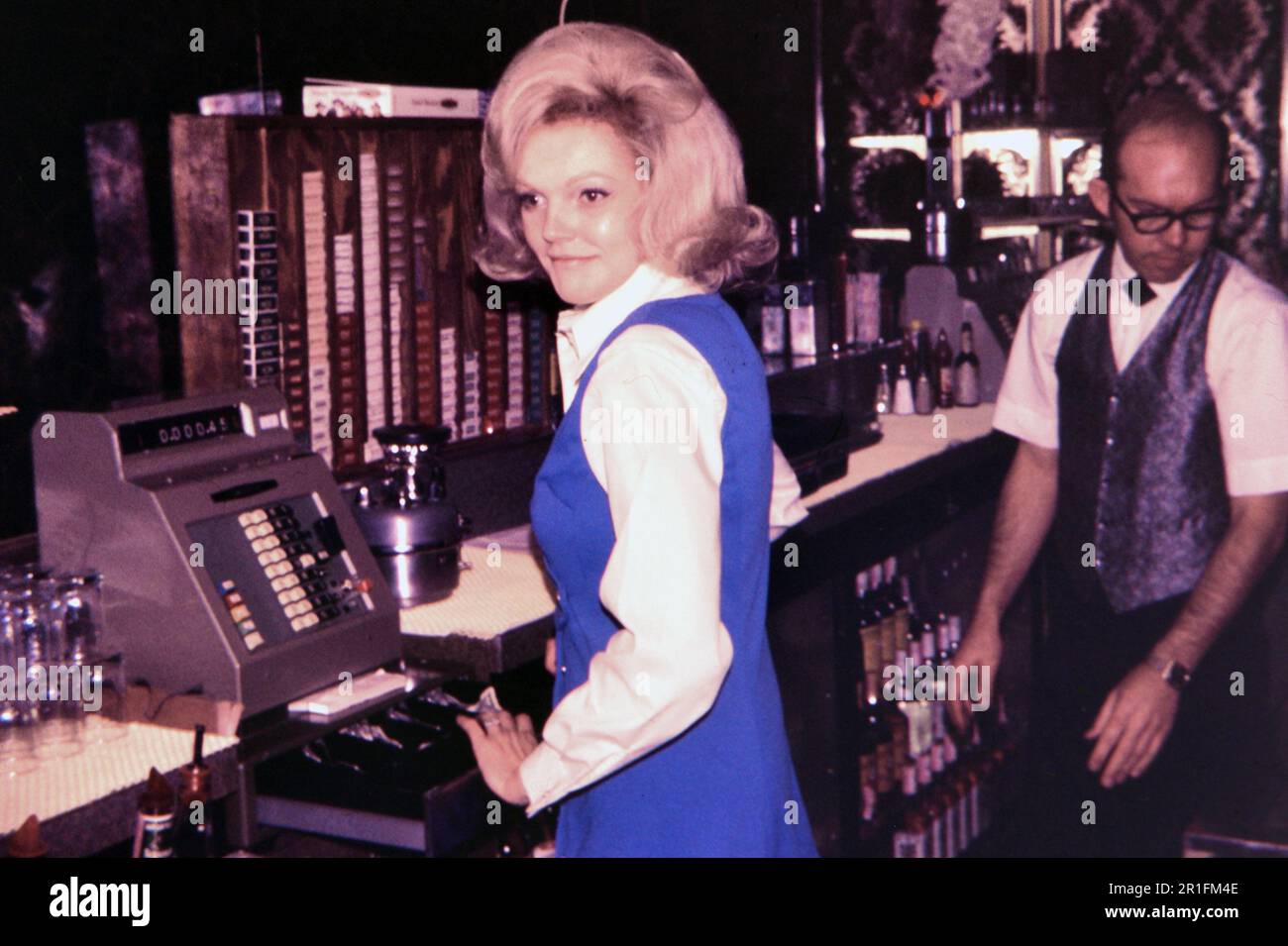 Woman cashier at a cash register in a bar ca. 1960s Stock Photo Alamy