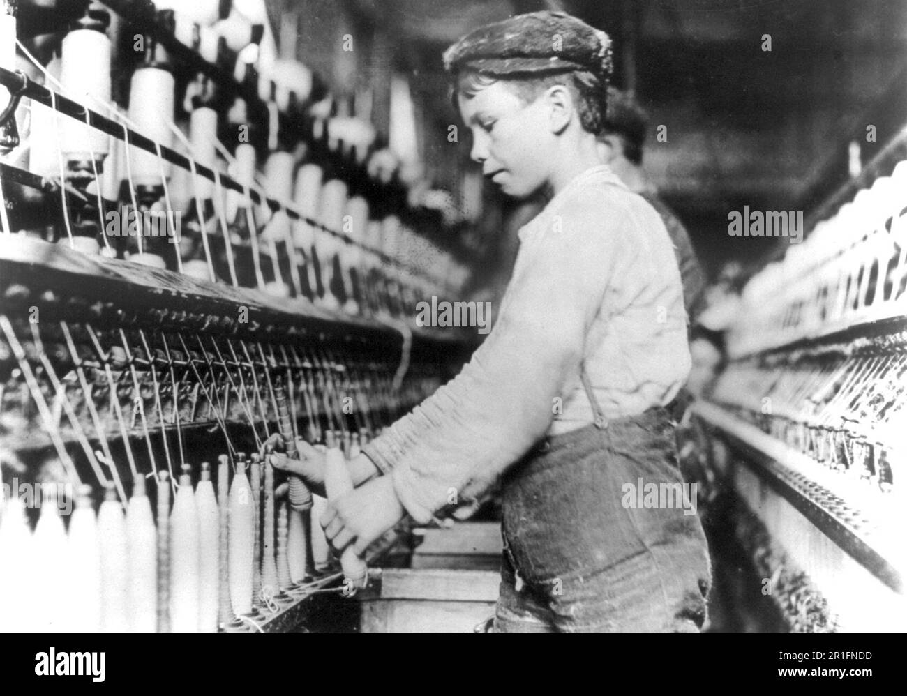 Archival Photo: (child labor) Doffer boy in Globe Mills, Augusta, Georgia ca. 1909-1932 Stock Photo