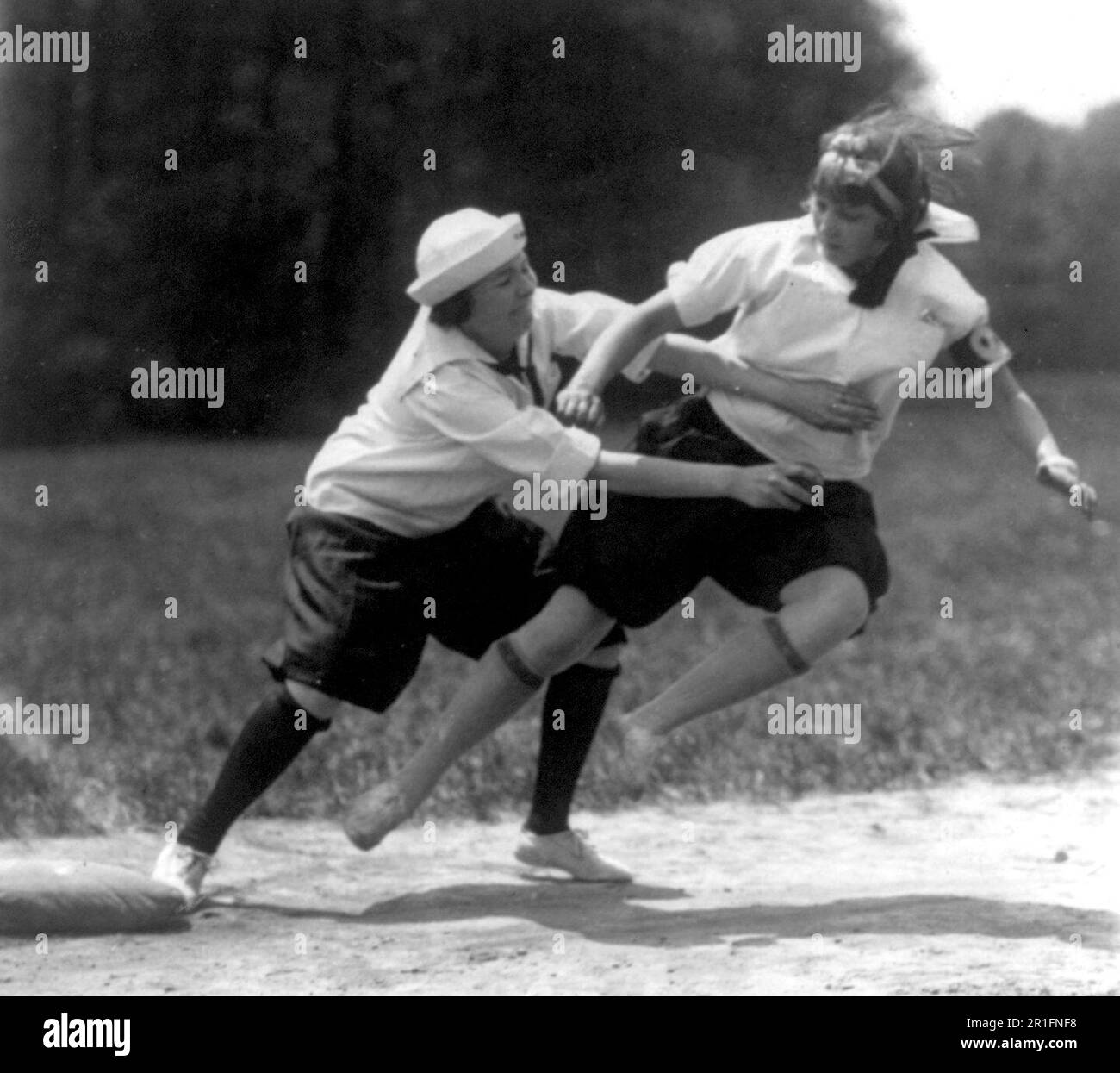 Archival Photo: Virginia Smoot of Columbia Jr. High School tagged out at third by Mabel Harvey of McFarland School during the ball game ca. 1925 Stock Photo