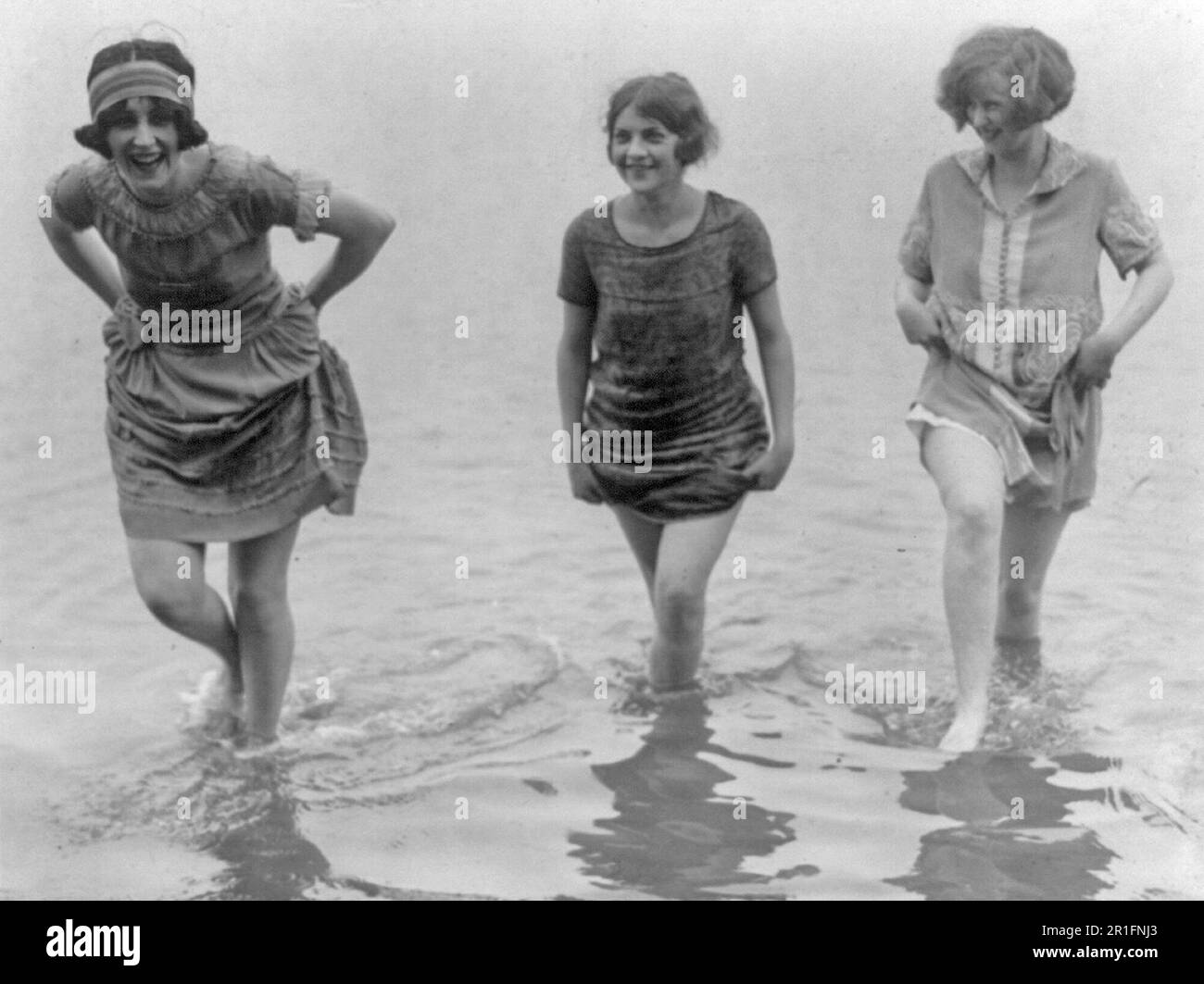 Archival Photo: Three models from Washington's spring fashion show wading at Arlington Beach ca. 1924 Stock Photo