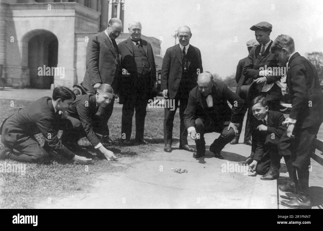Archival Photo: A marble championship between Senator and Pages - Senator Ralston leading off - Senators Magnus Johnson, Overman and Fess waiting their turn ca. 1924 Stock Photo