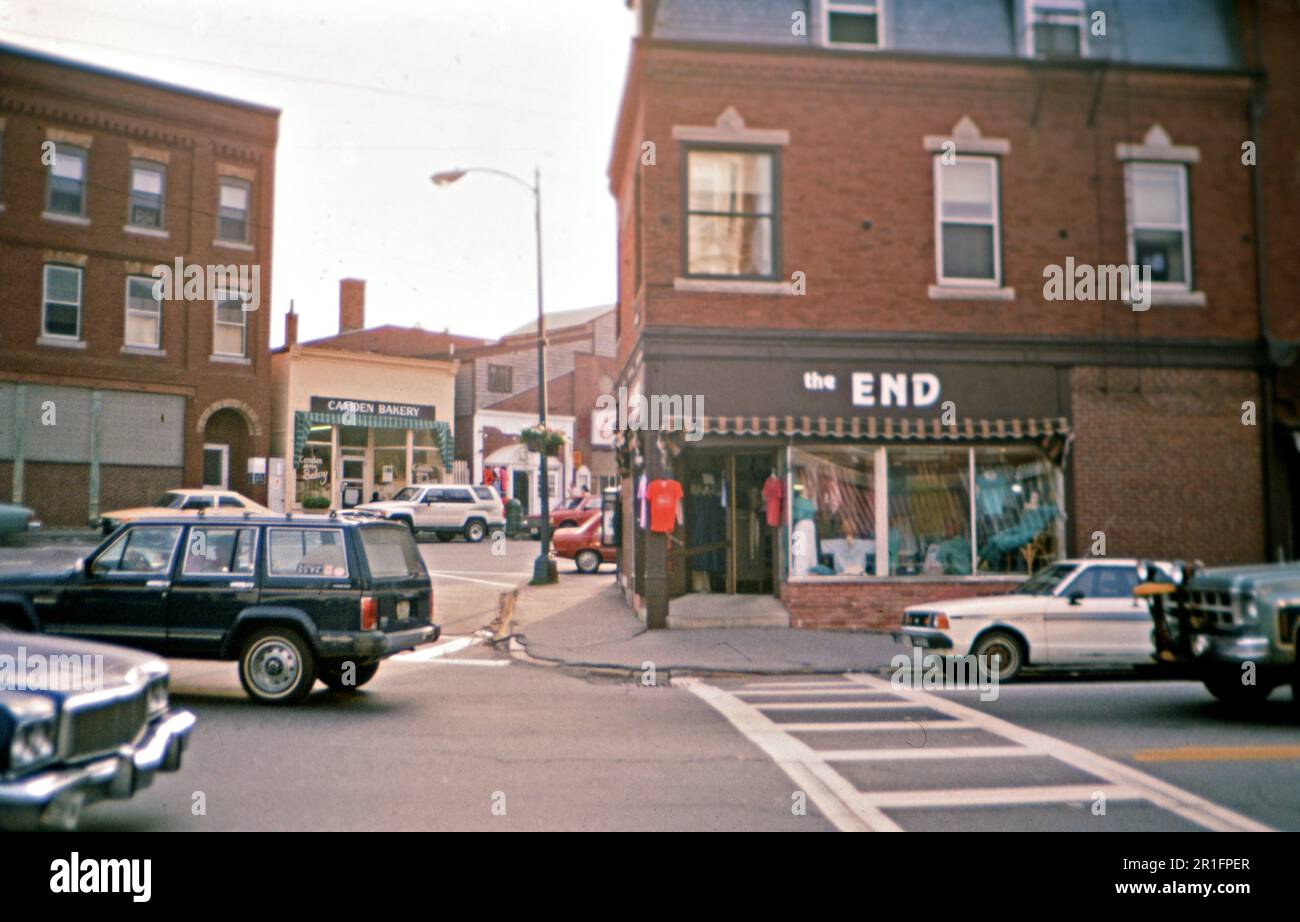 Traffic in downtown Camden Maine, cars driving by a store called, "The