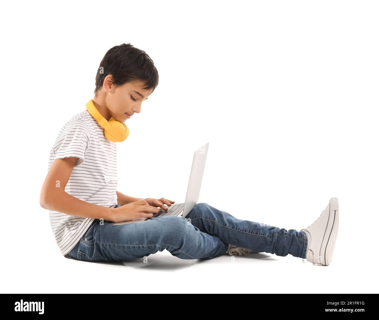 Little boy using laptop on white background Stock Photo - Alamy