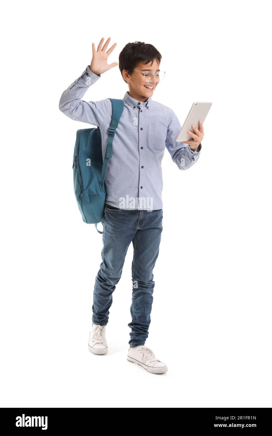 Little schoolboy using tablet computer on white background Stock Photo ...