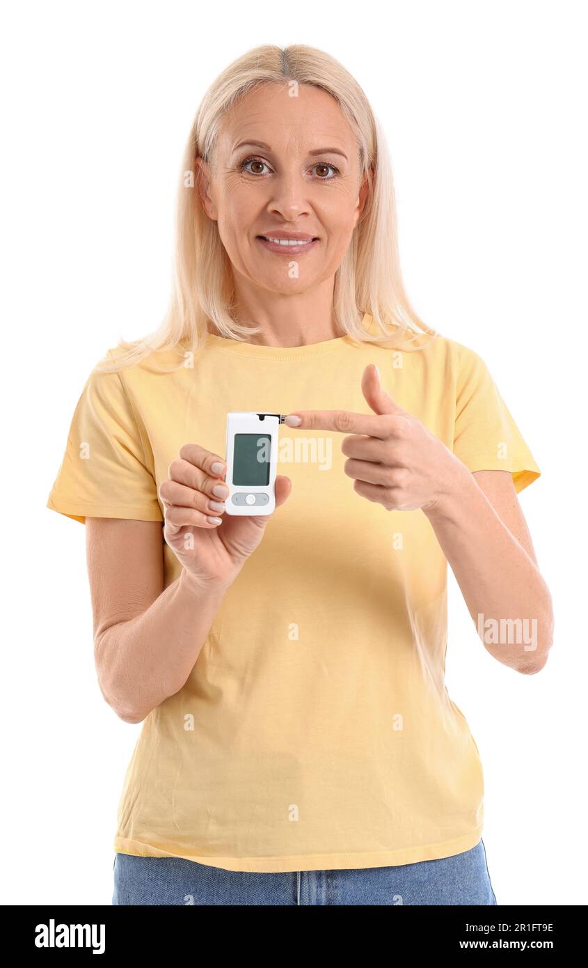 Mature diabetic woman measuring blood sugar level with on white background Stock