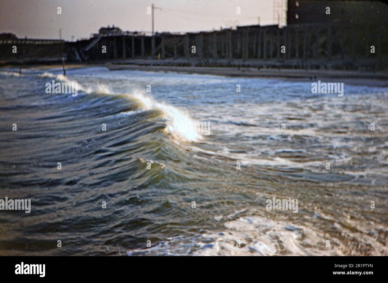 Wave coming ashore at Long Branch New Jersey, boardwalk in the background ca. 1955 Stock Photo