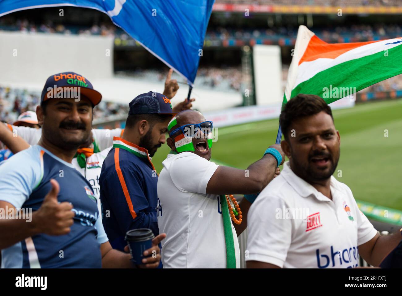 Melbourne, Australia, 27 December, 2020. Indian fans with face paint can be seen cheering and waving flags during day two of the Second Vodafone Test cricket match between Australia and India at the Melbourne Cricket Ground on December 27, 2020 in Melbourne, Australia. Credit: Dave Hewison/Dave Hewison Stock Photo