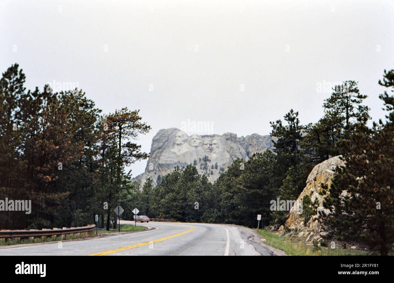 A car driving on a highway near Mount Rushmore in South Dakota ca. 1987