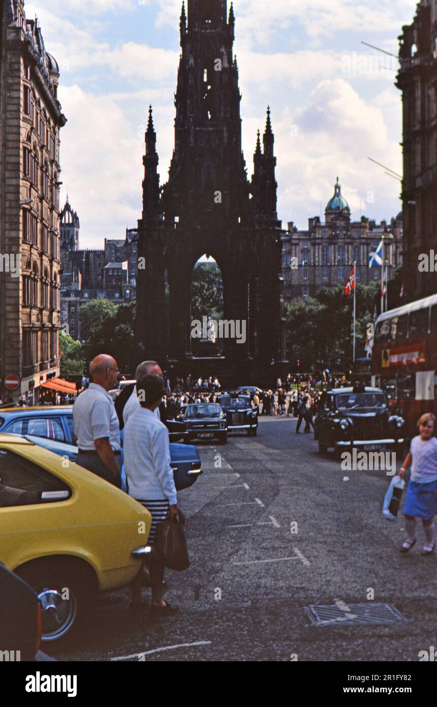 Parked cars and busy street and in the background, the Scott Monument in Edinburgh Scotland, UK ca. 1982 Stock Photo