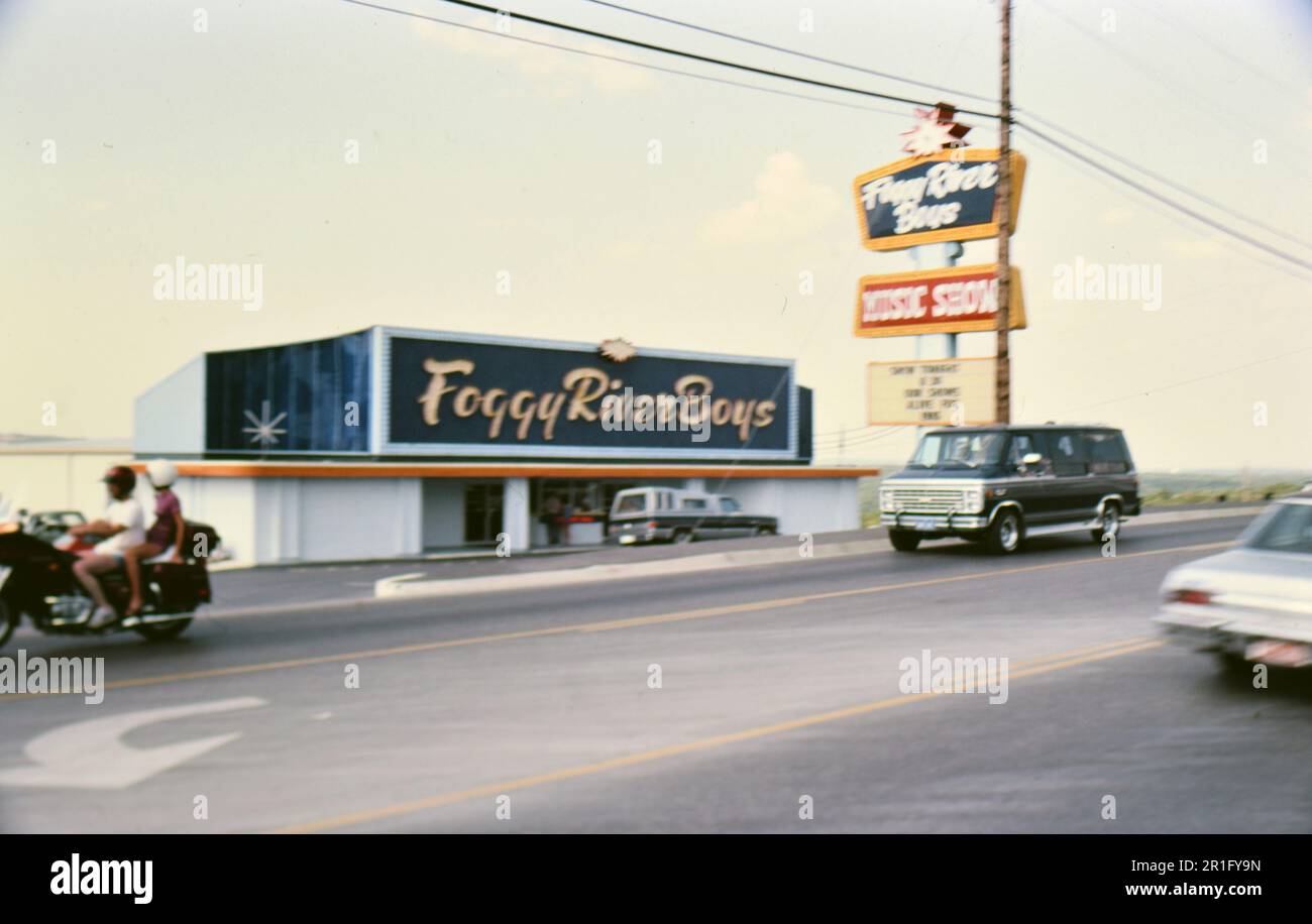 Van driving by the Foggy River Boys Music Show theater (probably in Missouri) ca. 1985 Stock Photo