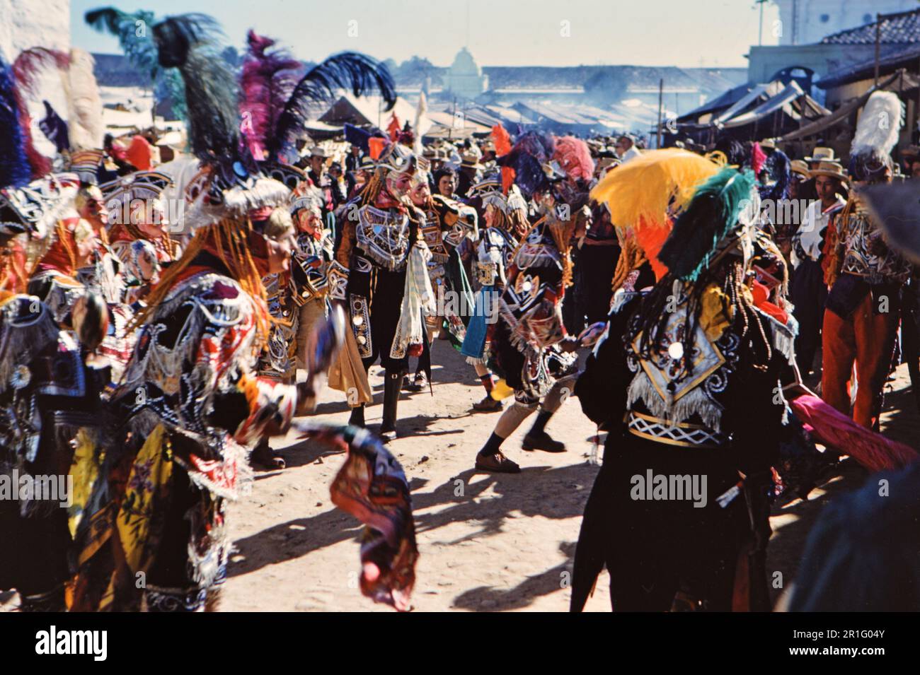 Dancers in the streets of Chichicastenango Guatemala, likely a Mayan celebration ca. 1962 Stock Photo