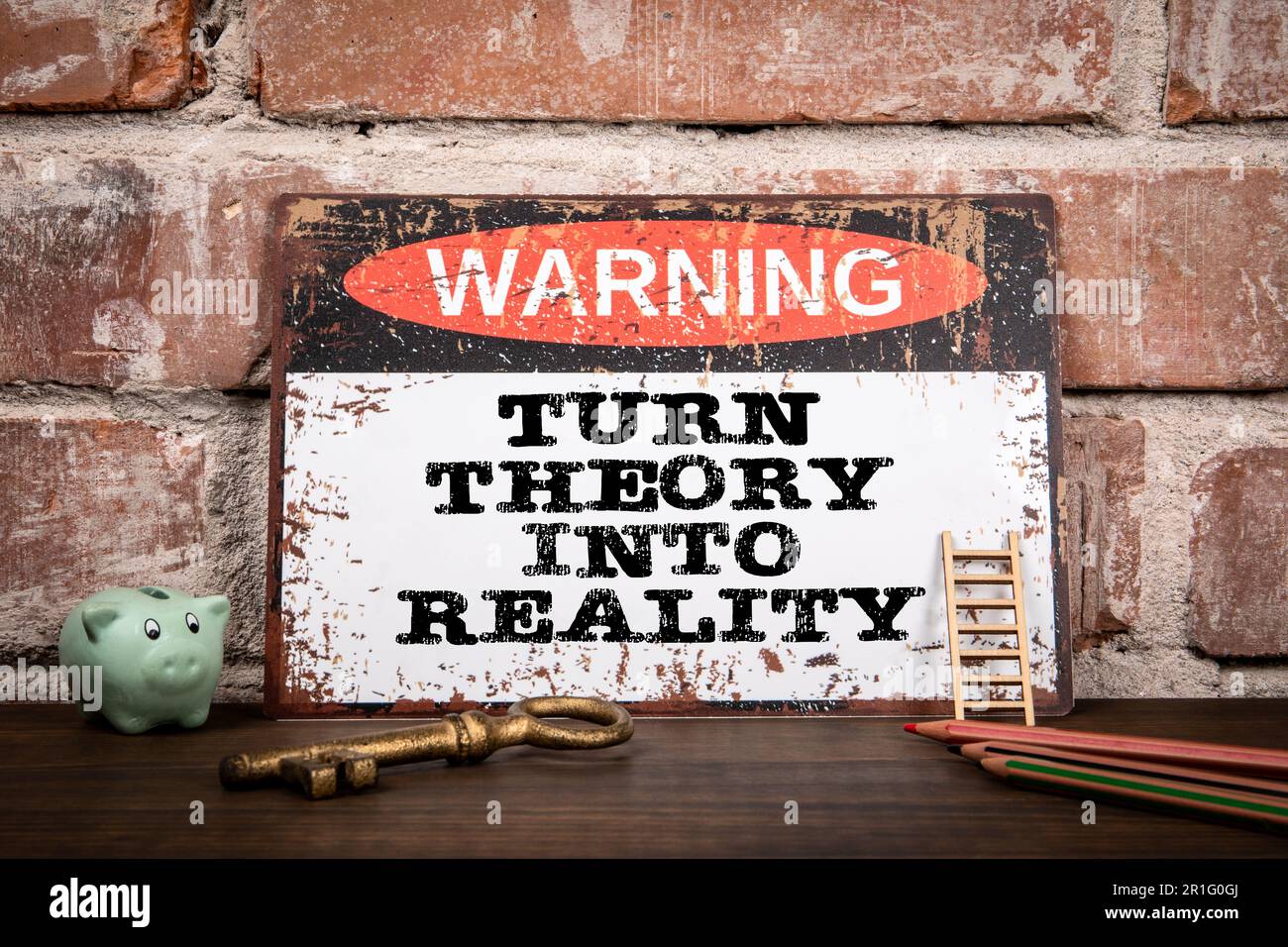 Turn Theory Into Reality. Warning sign on wooden texture office desk ...
