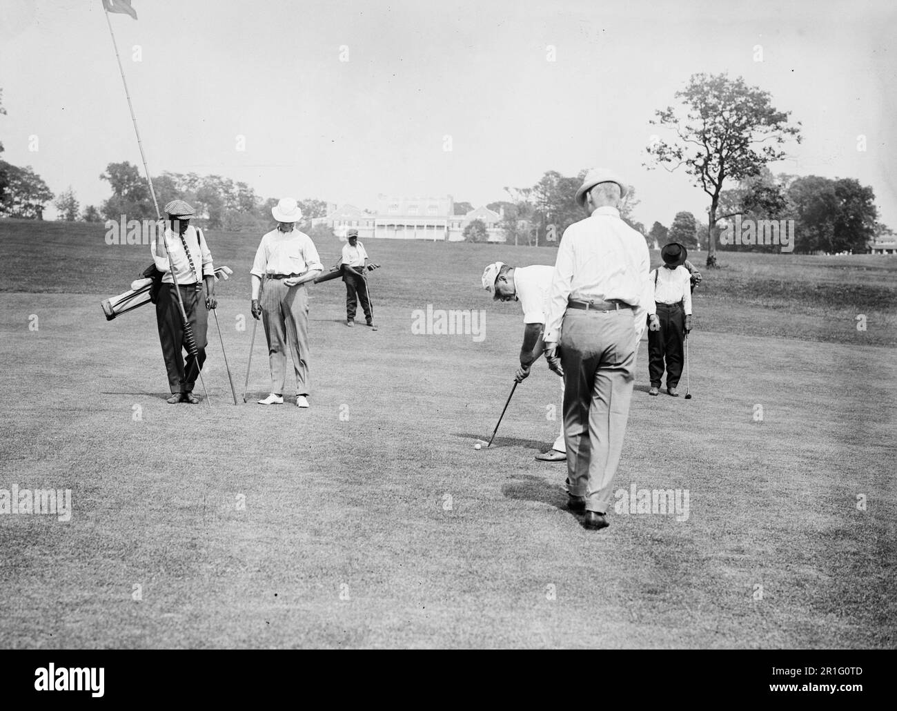 Archival Photo: Men on the green of a golf course in the early 20th century ca. 1910s Stock Photo