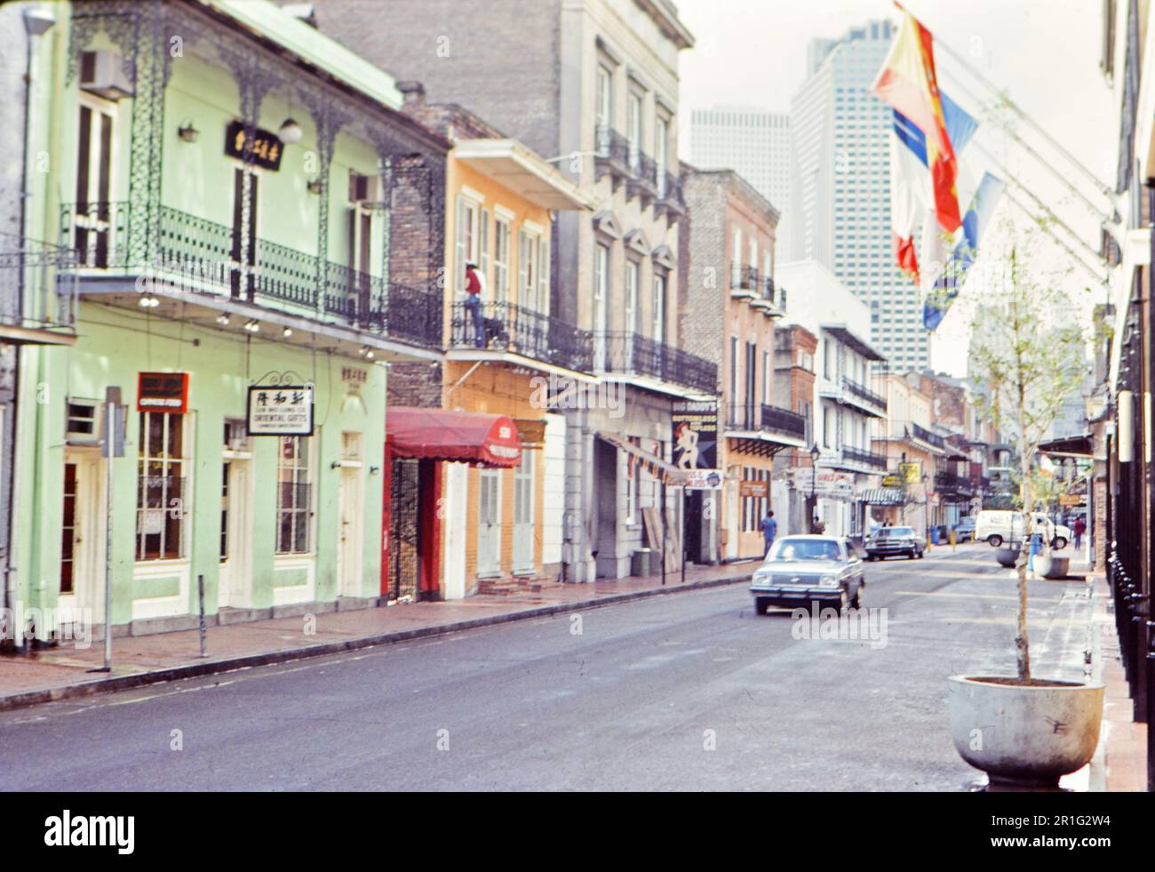Car driving down the 500 Block of Bourbon Street in New Orleans ca