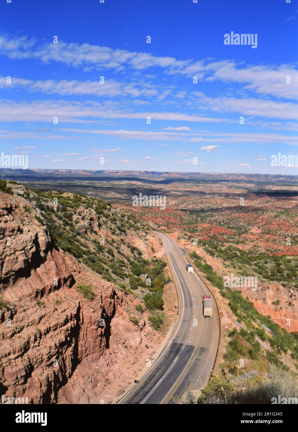 Two semi-trucks and trailers driving through Palo Duro Canyon in Texas  ca. 2000 Stock Photo
