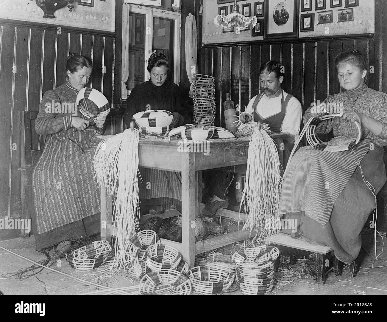 Archival Photo: An Austrian man and three women making baskets (basket weaving) ca. 1910s Stock Photo