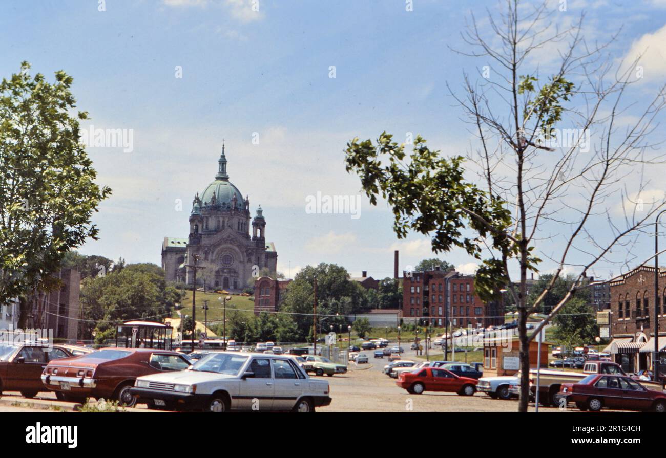 Cars parked in a parking lot with the Cathedral of Saint Paul in St