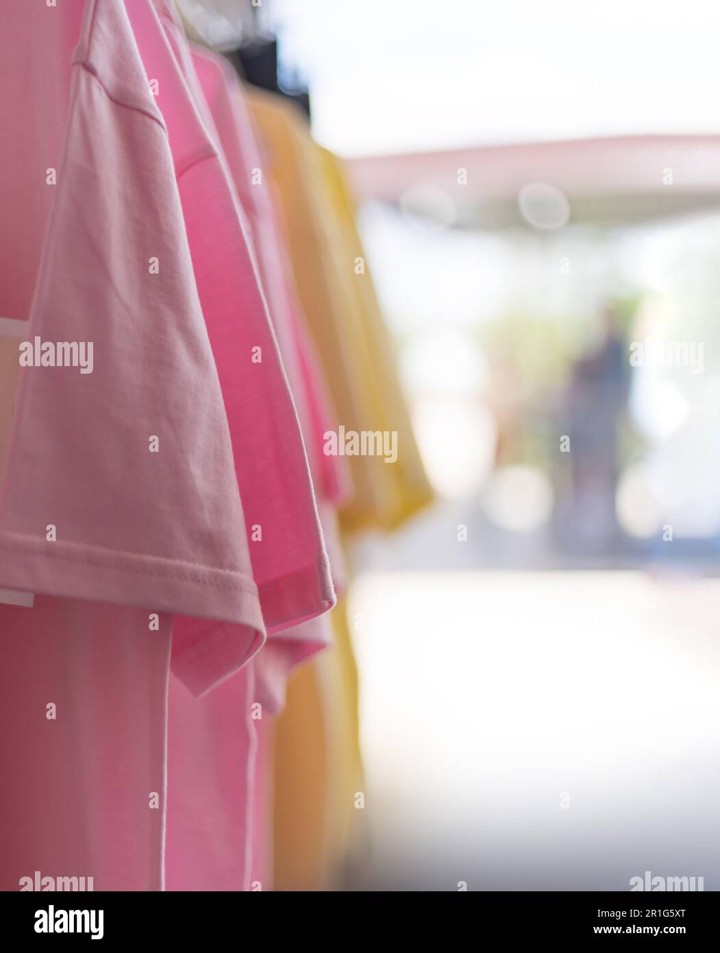T-shirts in pastel colors in the trading floor. Blurred background, selective focus. Stock Photo