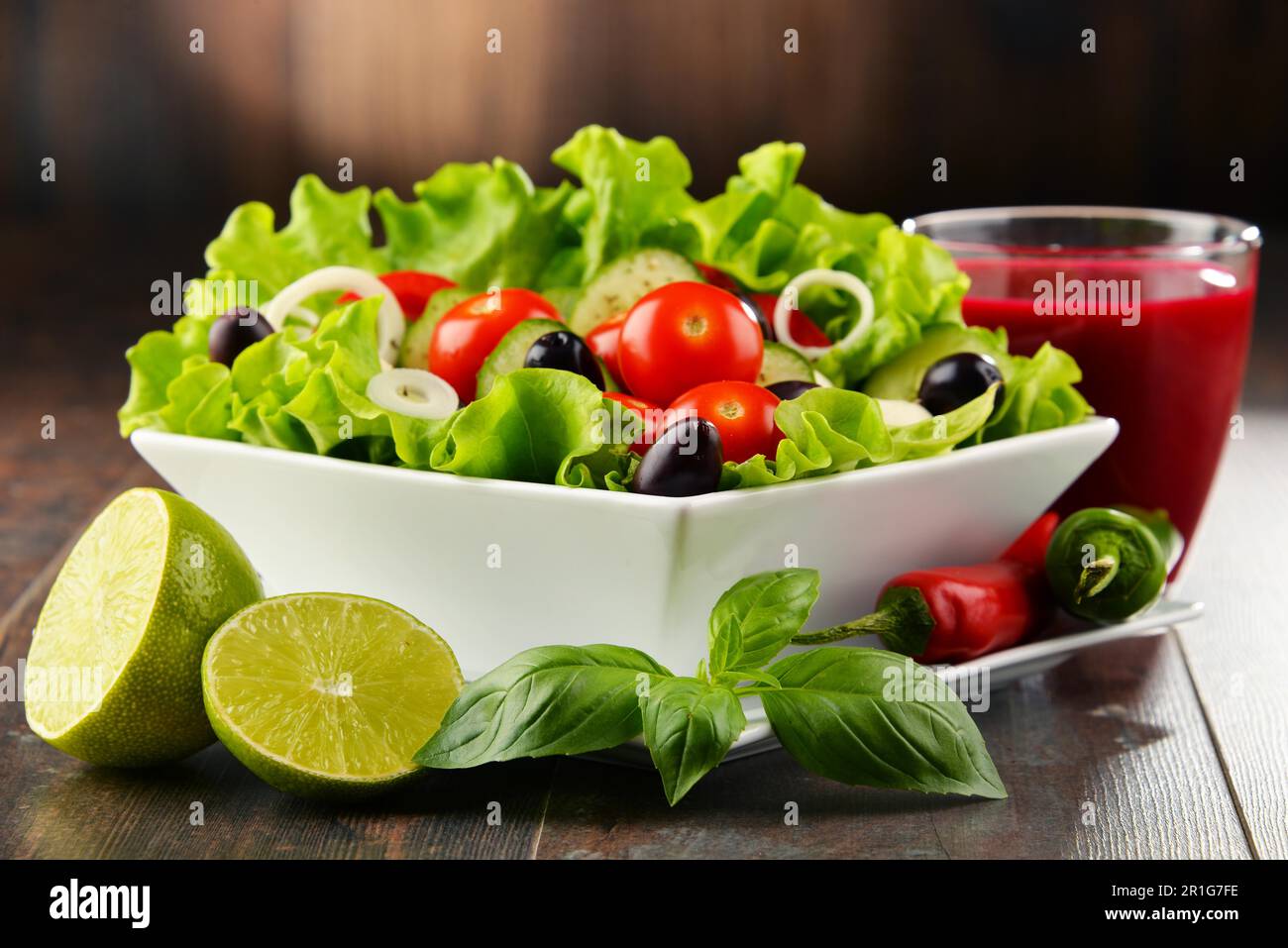 Composition with vegetable salad bowl and glass of juice. Balanced diet