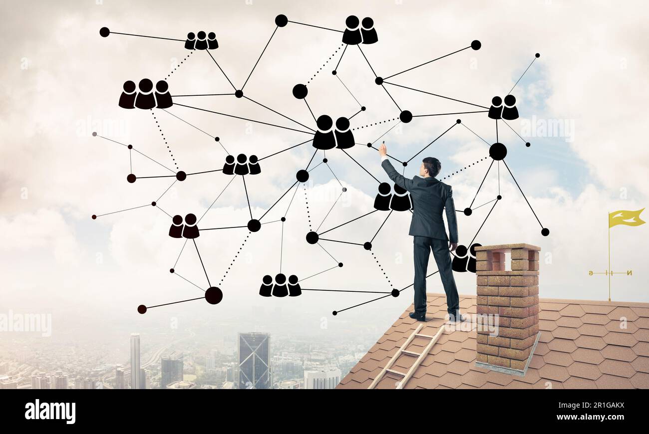 Businessman on house roof presenting networking and connection c Stock ...