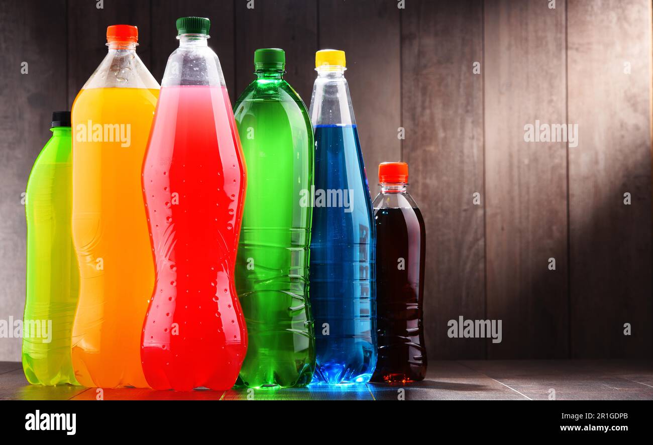 Plastic bottles of assorted carbonated soft drinks in variety of colors ...