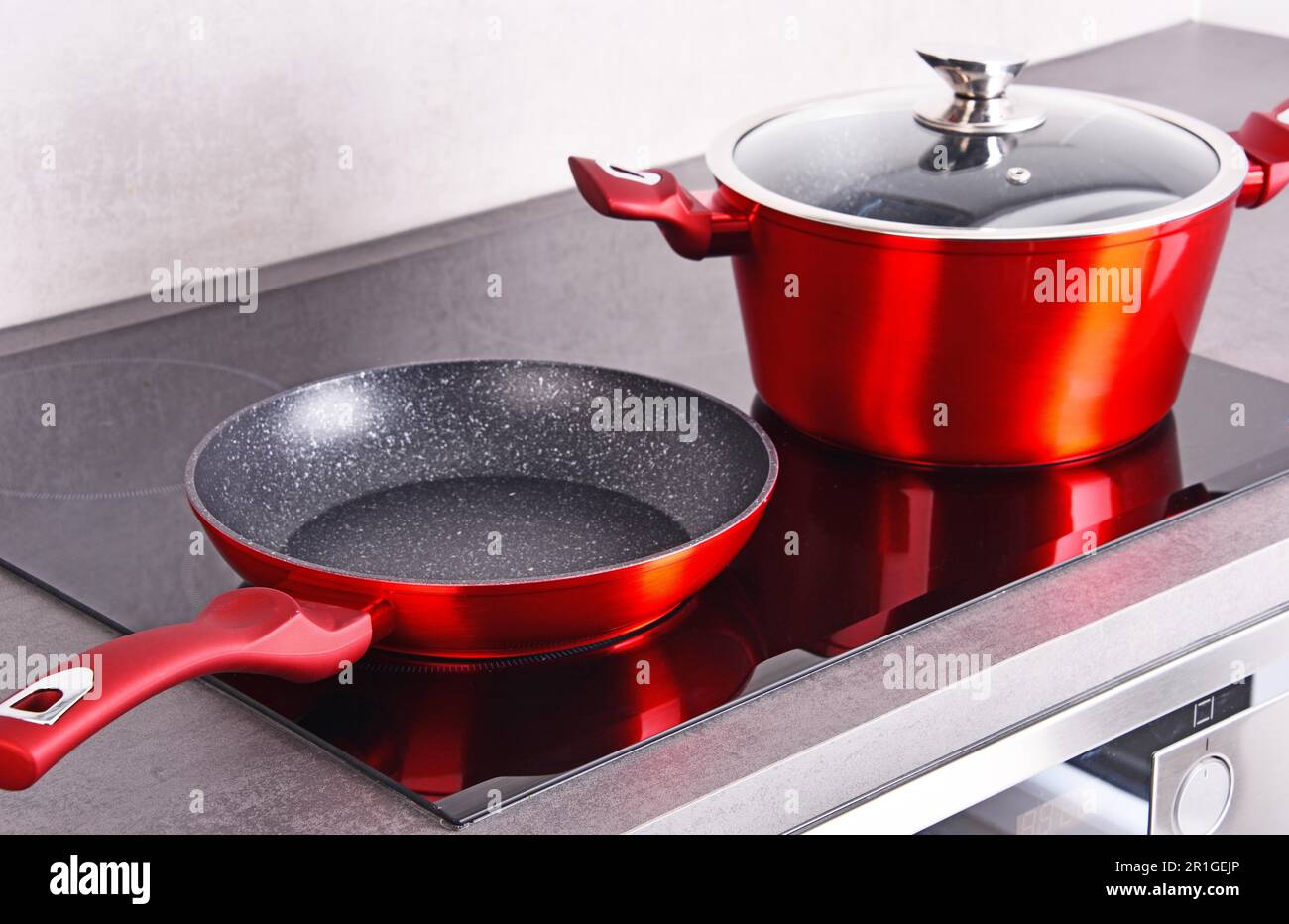 Frying pan and steel pot on modern induction cooktop Stock Photo Alamy